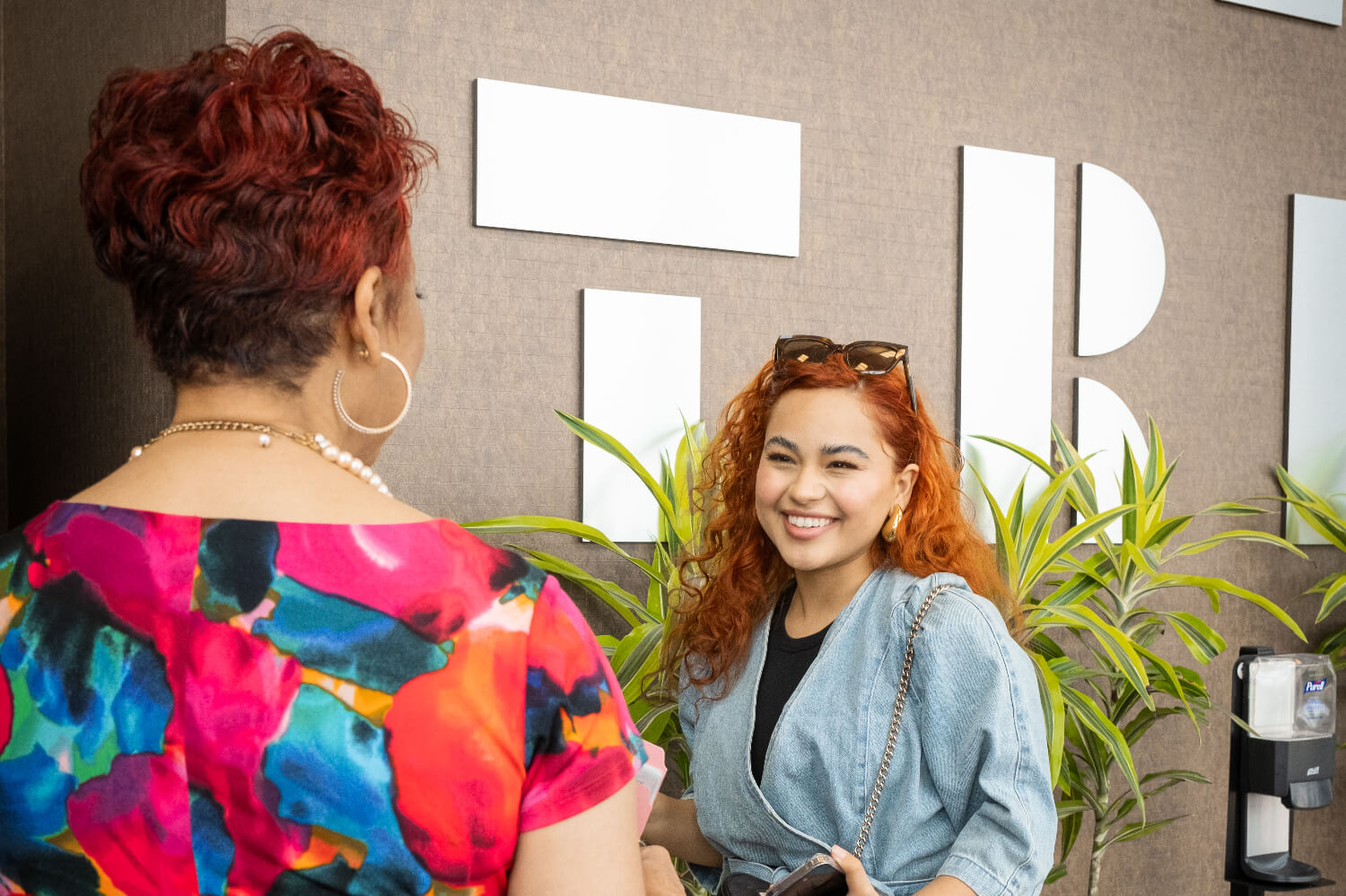 two women talking and smiling