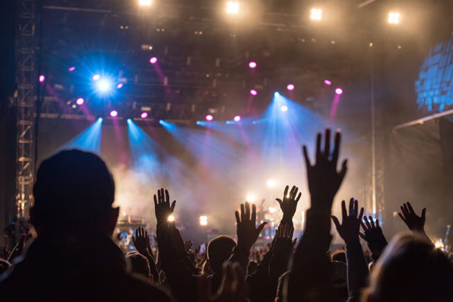 people raising hands in worship